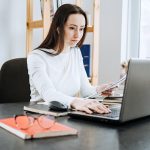 Remote Accounting Finance Jobs. Online Accounting Solution. Candid portrait of female accountant working with laptop, calculator and documents at home office.